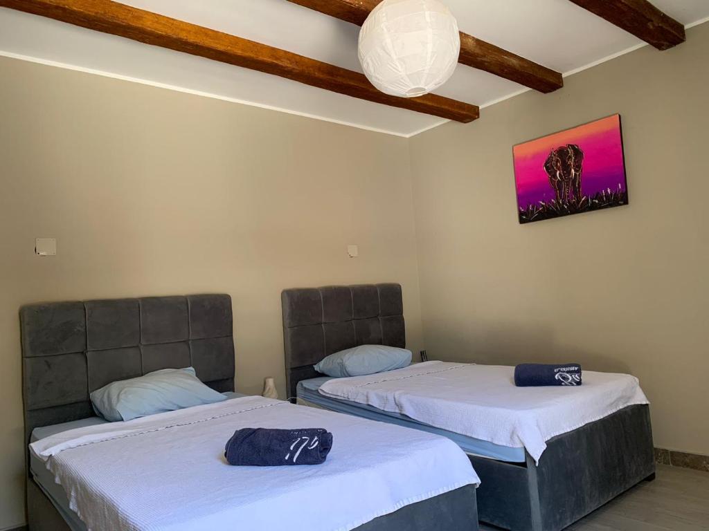 a room with two beds and a picture on the wall at Gouna 1 Bedroom Villa Private Pool & Patio Up to 5 Persons Bali in Hurghada