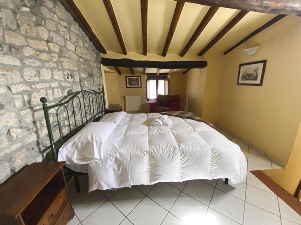 Postel nebo postele na pokoji v ubytování Borgo Giusto Tuscany