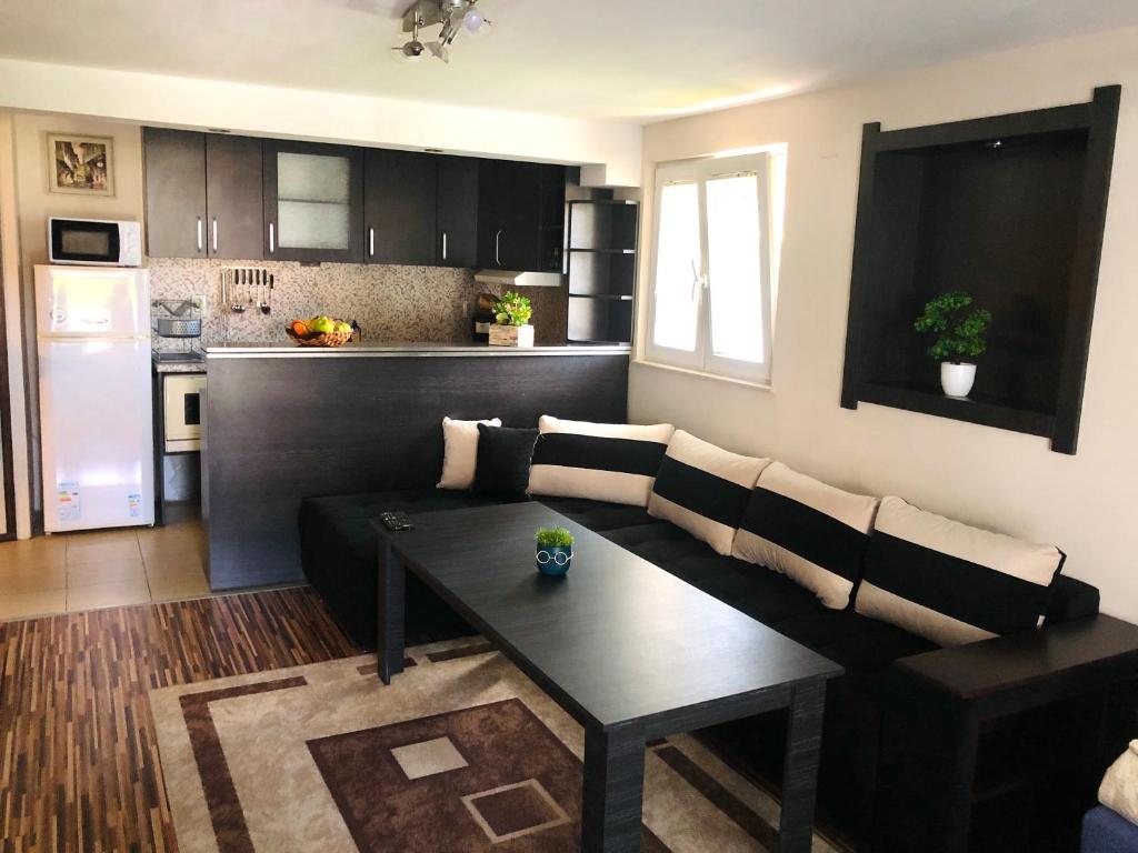 a living room with a couch and a table at Pavlovi Apartments in Samokov