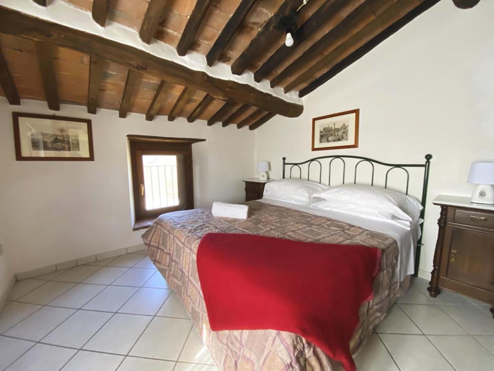 Postel nebo postele na pokoji v ubytování Borgo Giusto Tuscany