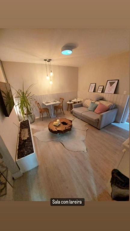 a living room with a couch and a table at Carpe Diem Boutique & Spa in Campos do Jordão