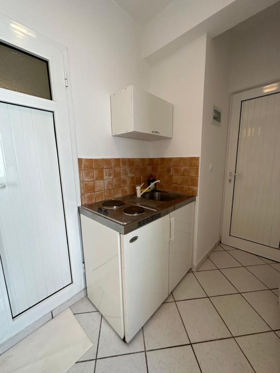 a small kitchen with a sink and a stove at Valente Rooms Kythira in Kythira