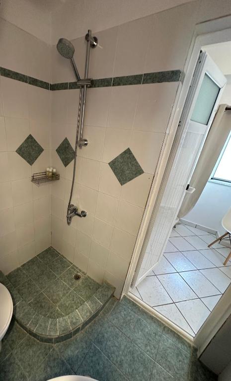 a bathroom with a shower with a toilet at Valente Rooms Kythira in Kythira