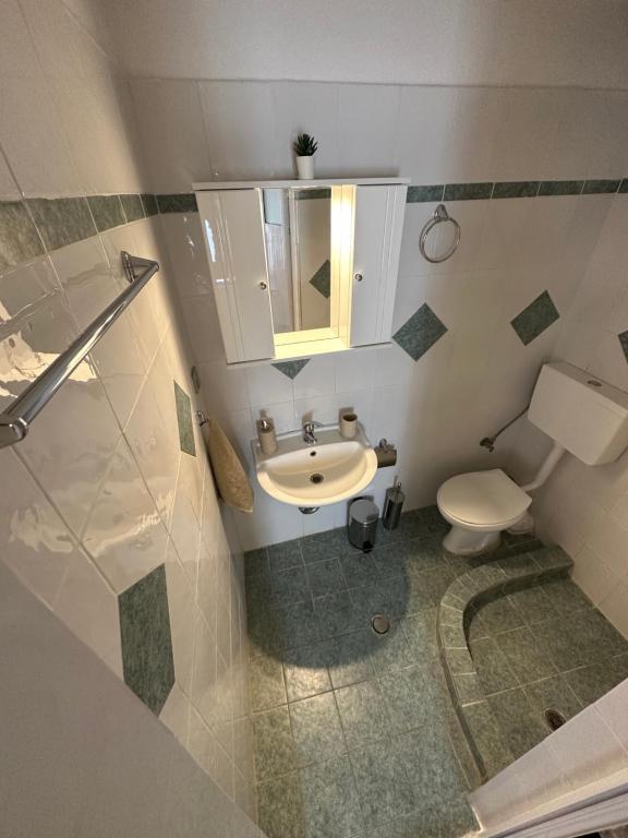 a bathroom with a sink and a toilet at Valente Rooms Kythira in Kythira