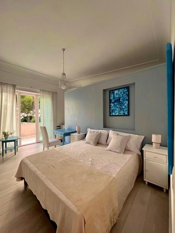 a bedroom with a large bed and a table at Cerio Guest House in Anacapri