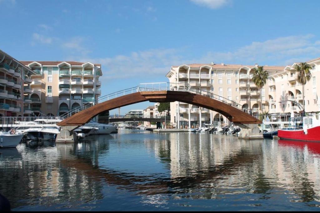 a bridge over a river in a city with buildings at T2/T3 duplex à Port Frejus proche de la mer in Fréjus