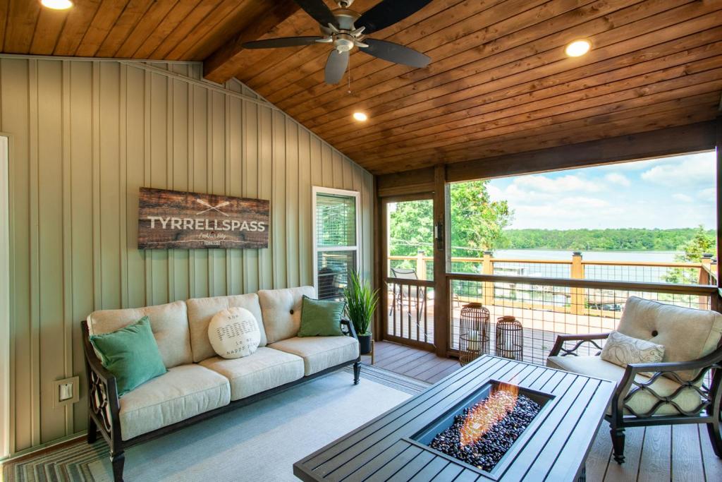a living room with a couch and a fireplace at Tyrrells Pass Lake Access with Hot Tub and Arcade in Lenoir City