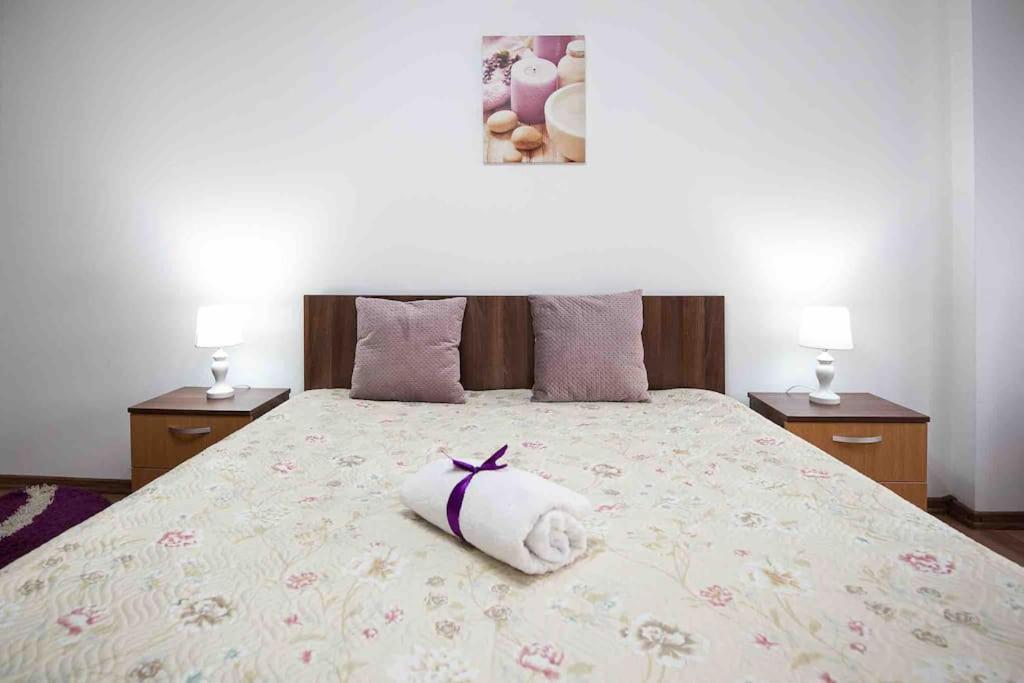 a bedroom with a bed with a towel on it at Camarad’s house - lovely apartment in Alba Iulia in Alba Iulia