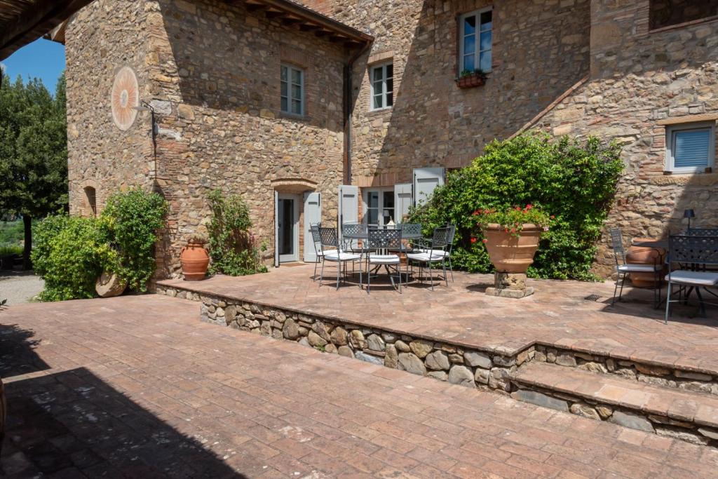 a patio in front of a stone building at Casale di Villore in Poggibonsi