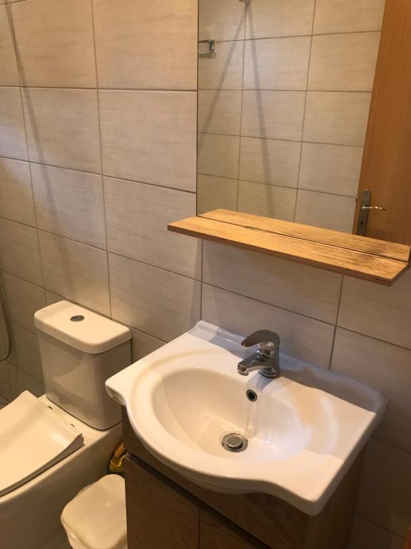 a bathroom with a sink and a toilet at Elena’s rooms in Virós
