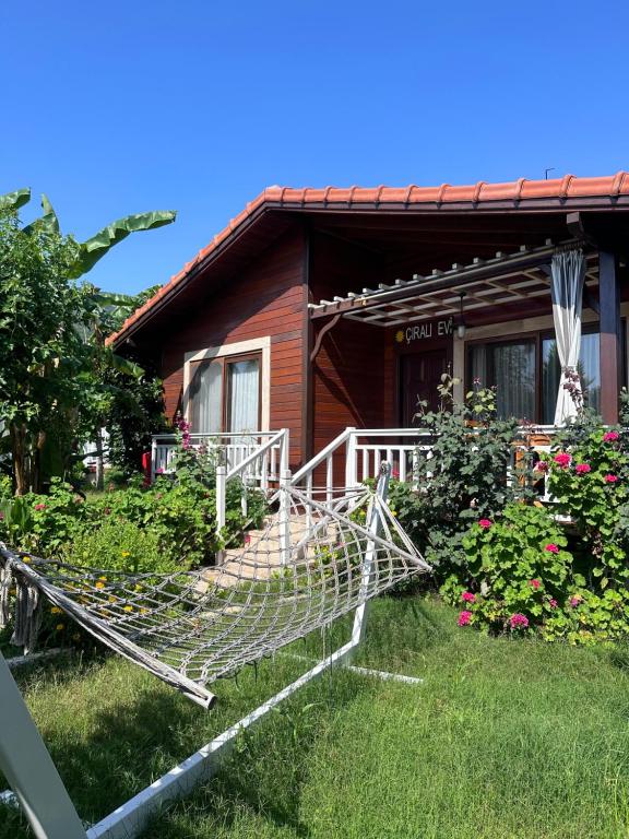 a house with a hammock in front of it at Rüya Villen Park in Cıralı