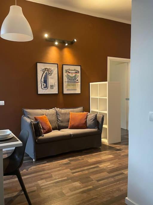 uma sala de estar com um sofá num quarto em casa boutique em Ivrea