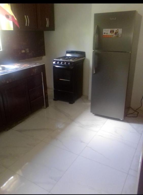 a kitchen with a stainless steel refrigerator and a stove at Home away from home 