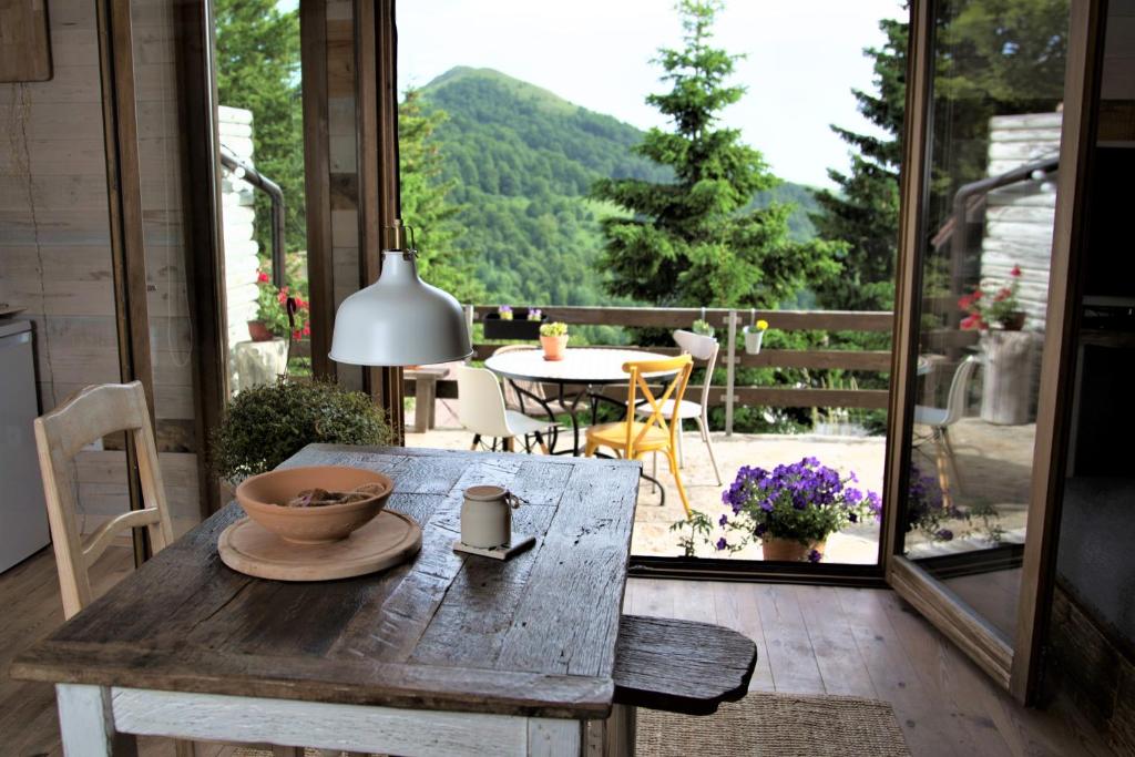 a wooden table with a bowl on it on a patio at Kostovac Boutique Homes - Apartment with Sauna in Kopaonik