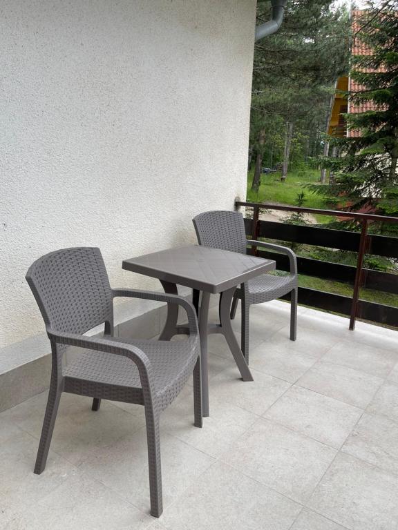 two chairs and a table on a patio at Smeštaj Nedić Karaula in Zlatibor