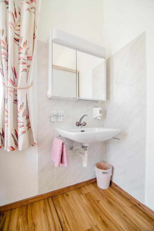 a bathroom with a sink and a mirror at Pensione Solaria in Locarno