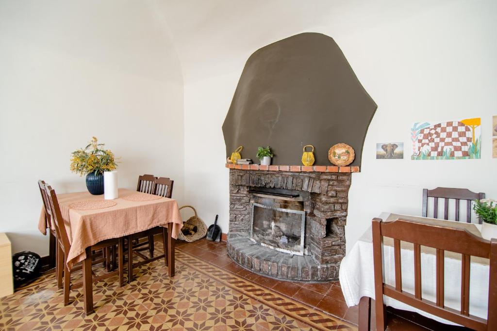 a dining room with a table and a fireplace at Pensione Solaria in Locarno