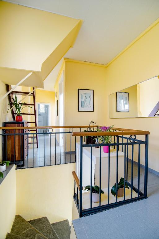 a staircase in a house with shoes on the floor at Pensione Solaria in Locarno