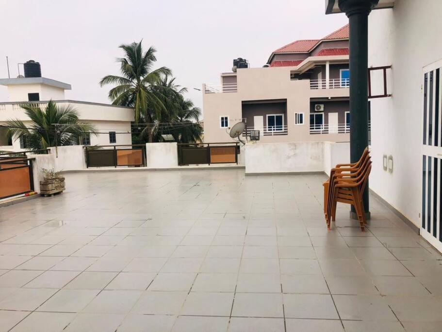 a patio with a chair on top of a building at illémi Guest house in Abomey-Calavi