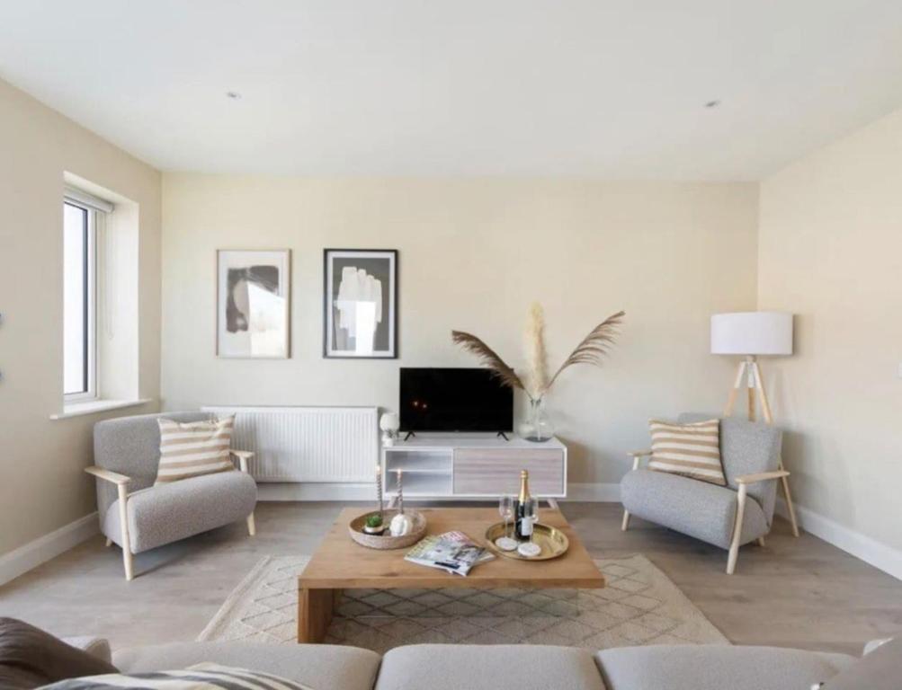 a living room with a couch and a table at Luxury Seaview Apartment in Dublin