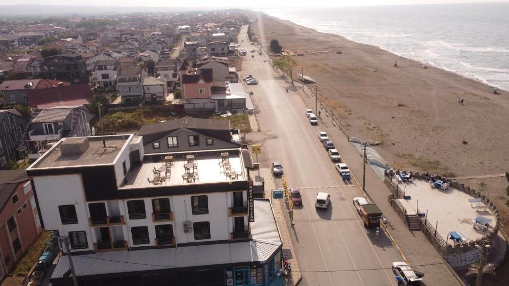 een luchtzicht op een strand met huizen en auto's bij RÜYA PANSİYON APART OTEL in Yukarı Kocaali