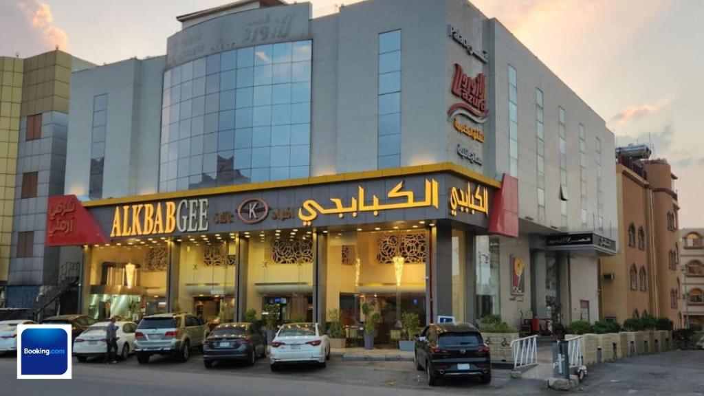 a large building with cars parked in front of it at قصر لازورد in Taif