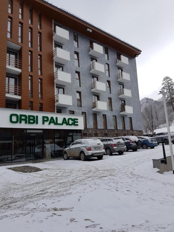 a parking lot in front of a apartment building at ORBI PALACE DeLuxe nice apartment in Bakuriani