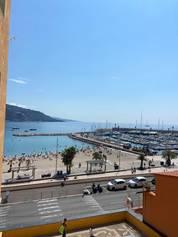 - une vue sur une plage avec des voitures garées sur la route dans l'établissement 20 rue longue, à Menton