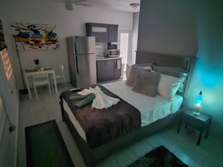 a bedroom with a bed with a dress on it at Urban Lodgings One @ Roosevelt 457 in San Juan