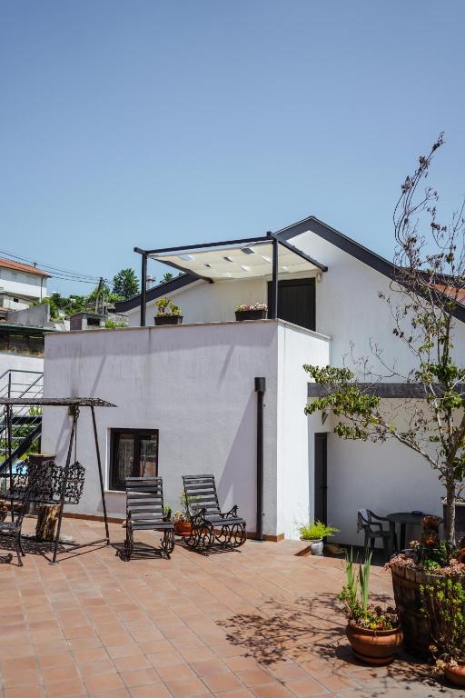 a group of chairs sitting on a patio at Casa de Luzes in Amarante