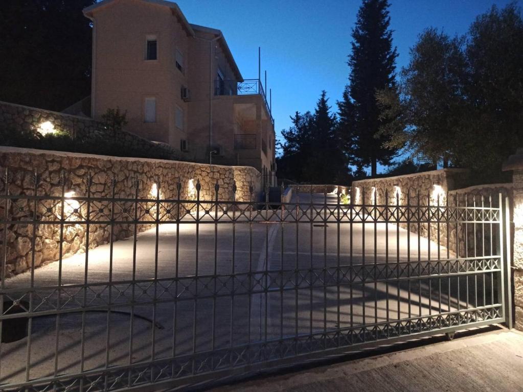 a gate in front of a building at night at GERAKOFOLIA-VILLA in Nikiana