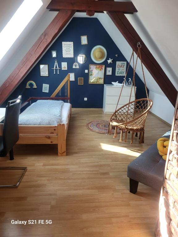 a attic room with a bed and a swing at Geräumige Wohnungen Zentrumsnah Schwandorf in Schwandorf in Bayern