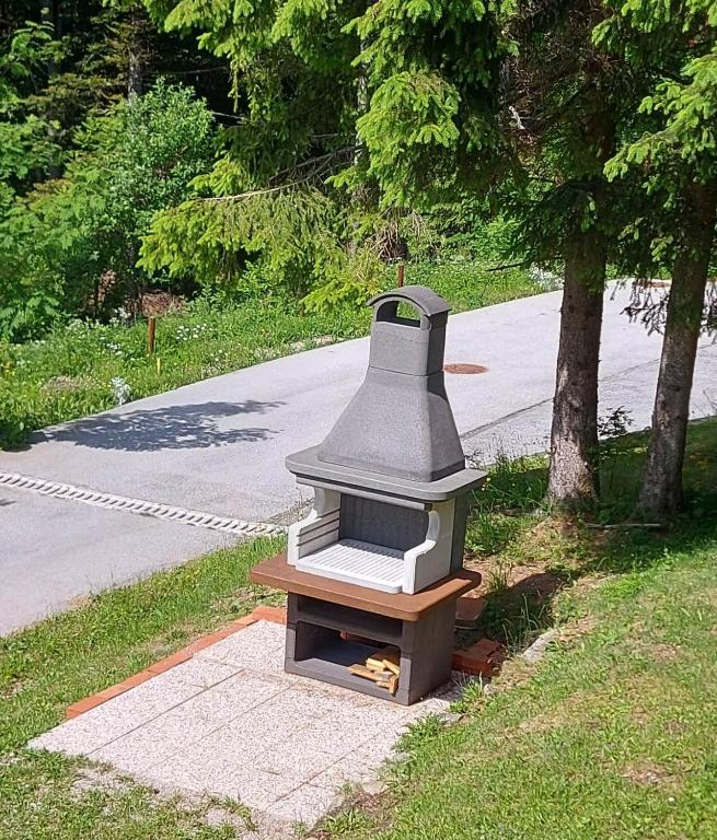 a bird house sitting on the side of a road at Rogla - Chalet Mojca Pokrajculja in Zreče