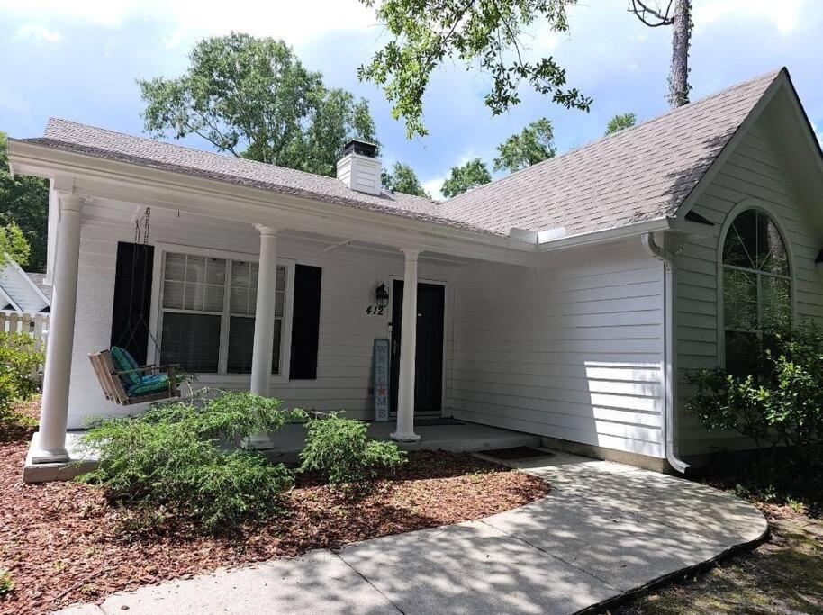 a small white house with a porch at Close to the beach and attractions! Perfect for families or traveling nurses! in Wilmington