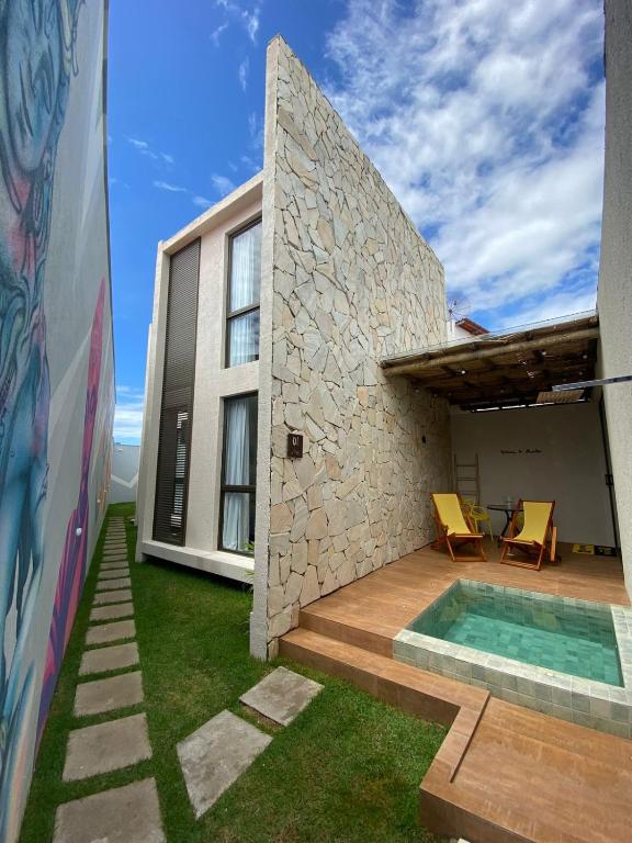 a house with a backyard with a swimming pool at Lotus Patacho in Pôrto de Pedras