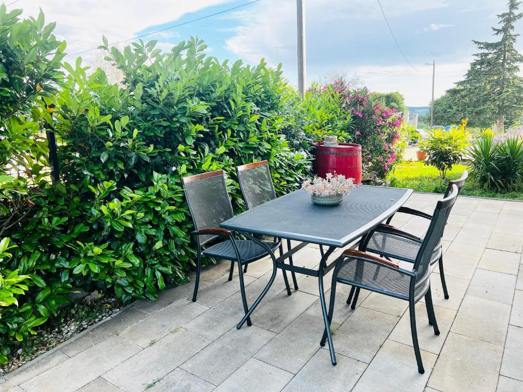a blue table and four chairs on a patio at Apartments Village in Lozovac