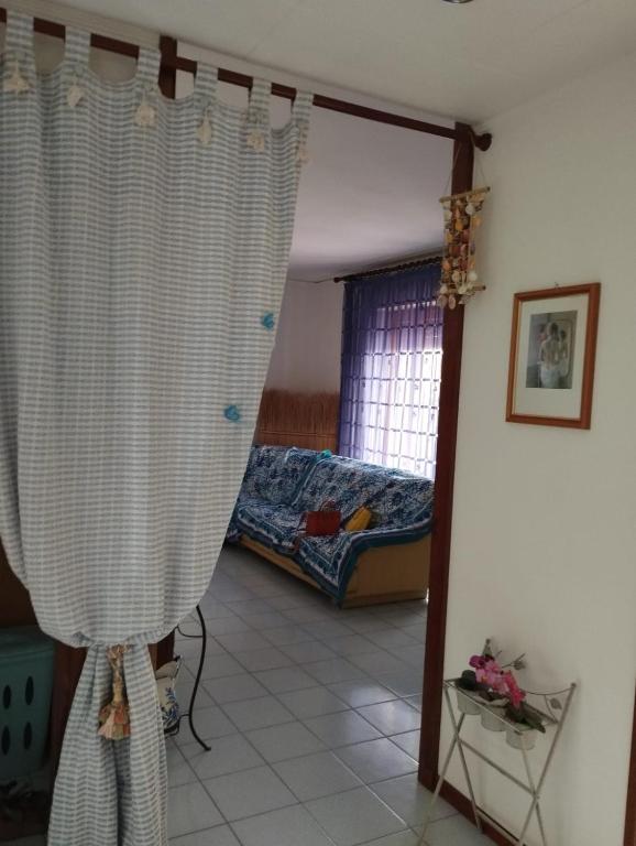 a bedroom with a bed and curtains in a room at CRISTIN B&B in Monfalcone
