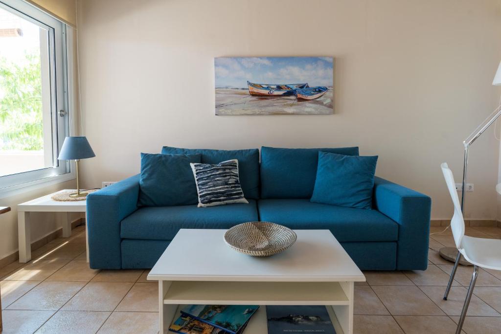 a blue couch in a living room with a table at Andreas House in Lixouri
