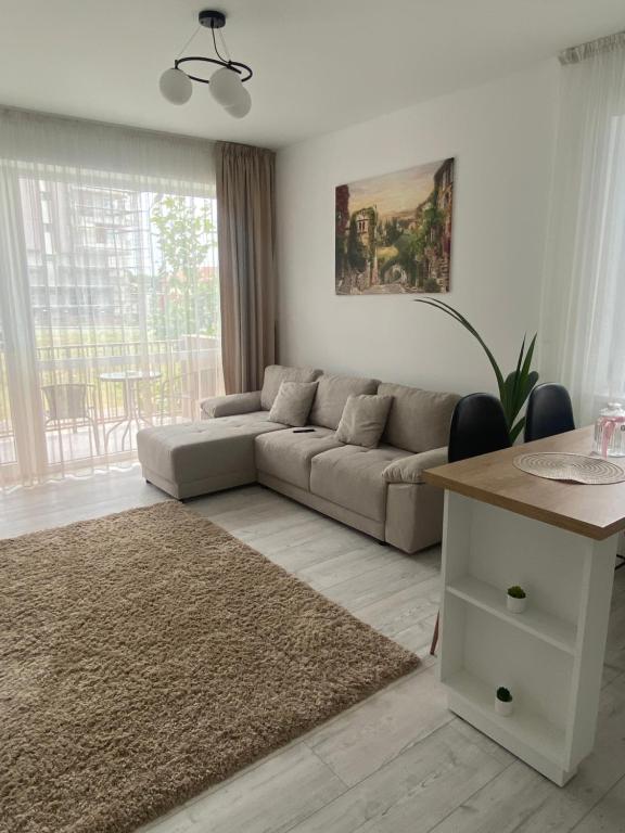a living room with a couch and a table at Good Vibes Apartment in Oradea