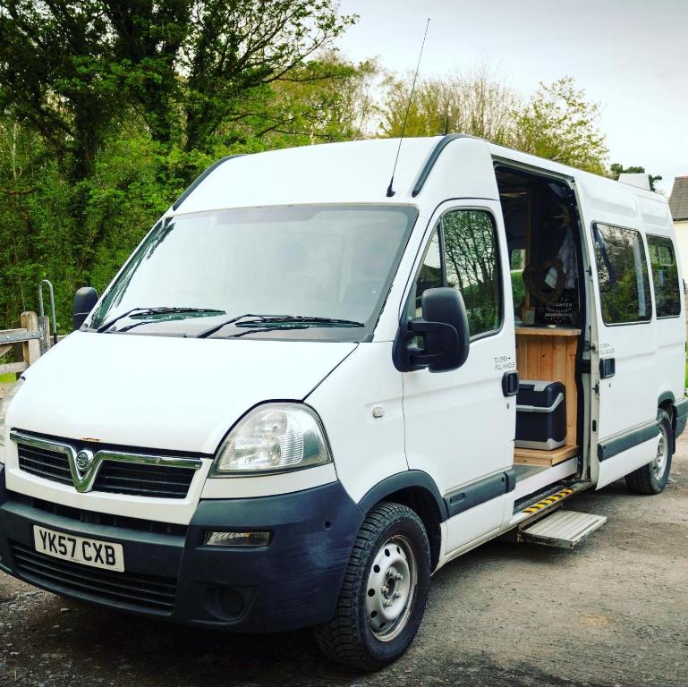 a white van parked in a parking lot at Annie The Ambulance (Drive away campervan) in Skewen