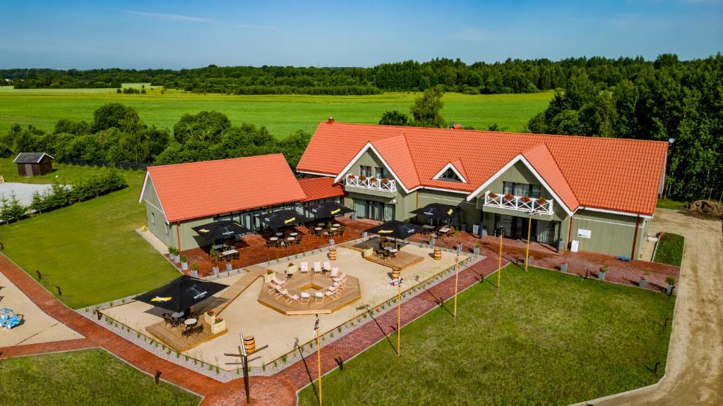 an aerial view of a house with a patio at Viešbutis SAKAI sodyboje Gribžė in Gribžiniai