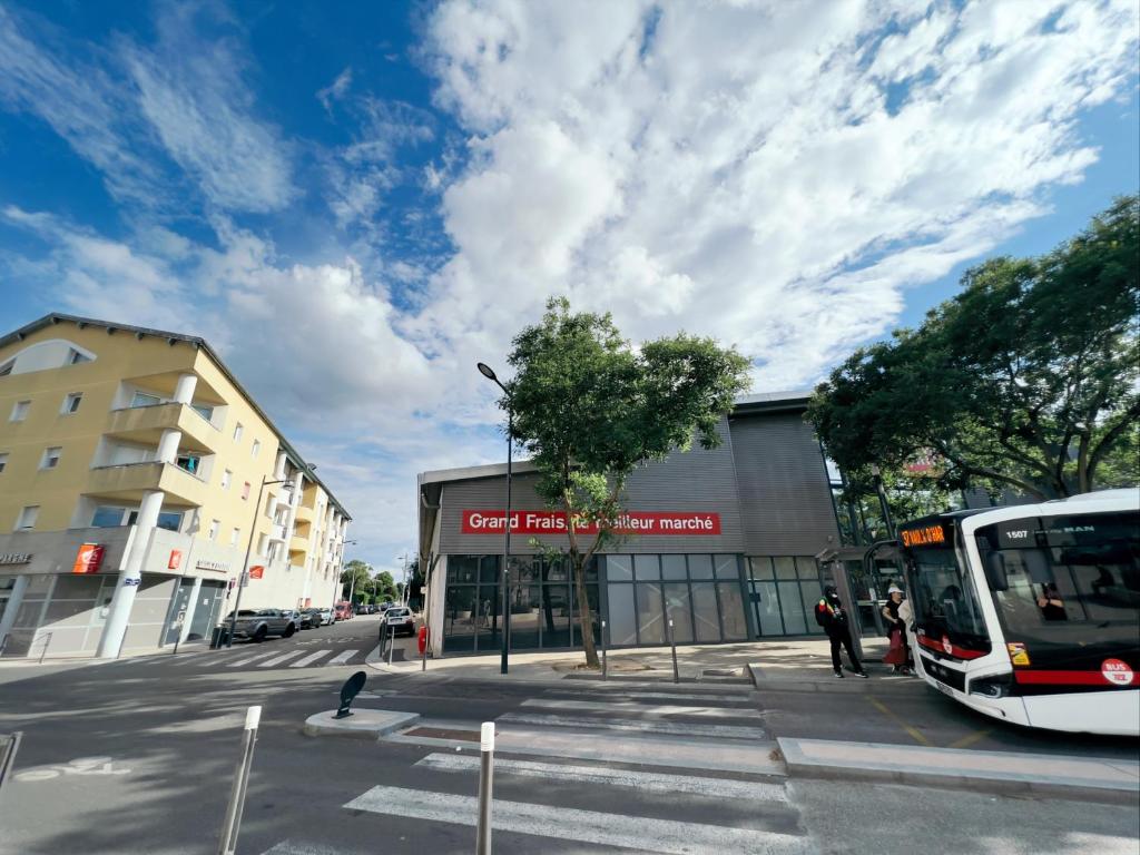 a bus is parked in front of a building at charmant studio in Vaulx-en-Velin
