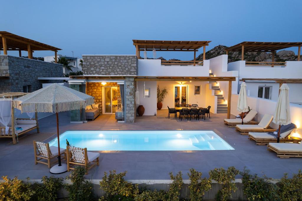 a villa with a swimming pool and a patio at OLIVES seaside villas (4elies) in Plaka