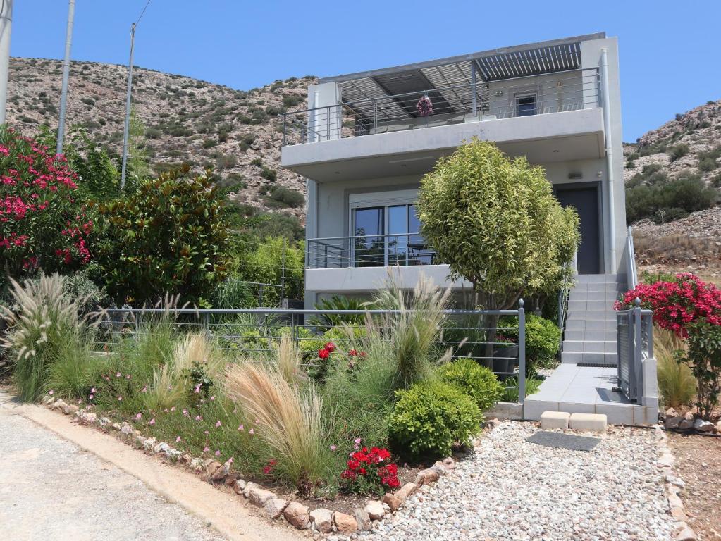 a house with a hill in the background at Patroclos SeaView in Sounio
