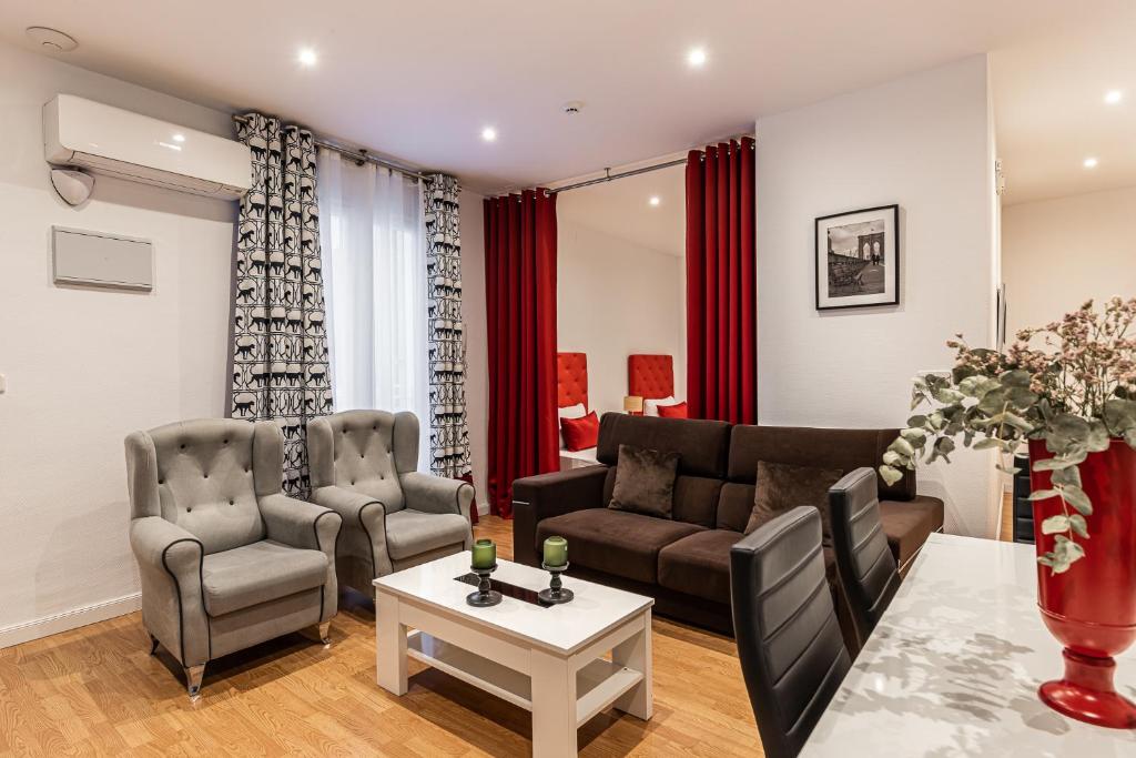 a living room with a couch and a table at BNBHolder Apartamentos en Sol Confort 8 in Madrid