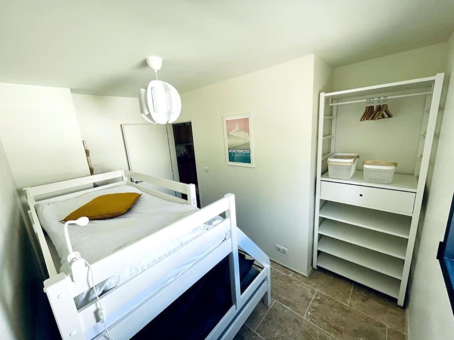 a hospital room with a bed and a closet at Chez Marien in Malaucène