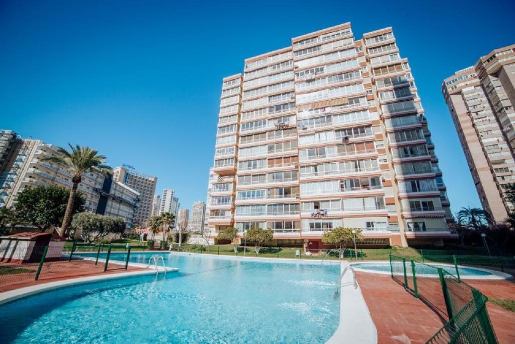 Hotel Lidersol, block 1, 8-B, a swimming pool in front of a tall building at Lidersol, block 1, 8-B in Benidorm