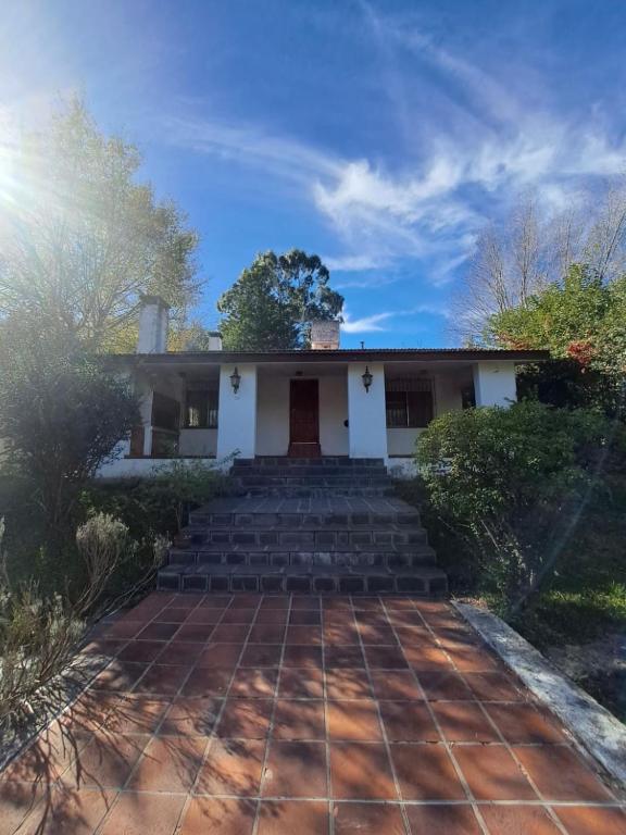 a white house with steps leading up to it at Las lavandas del colibrí in Alpa Corral