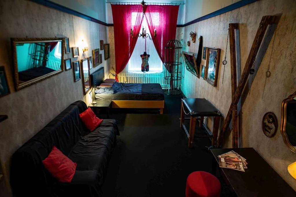 a living room with a couch and a window at Vintage BDSM Kinky Apartment - ENTIRE 65m2 space for up to 6-guests - FULLY EQUIPPED in Wrocław
