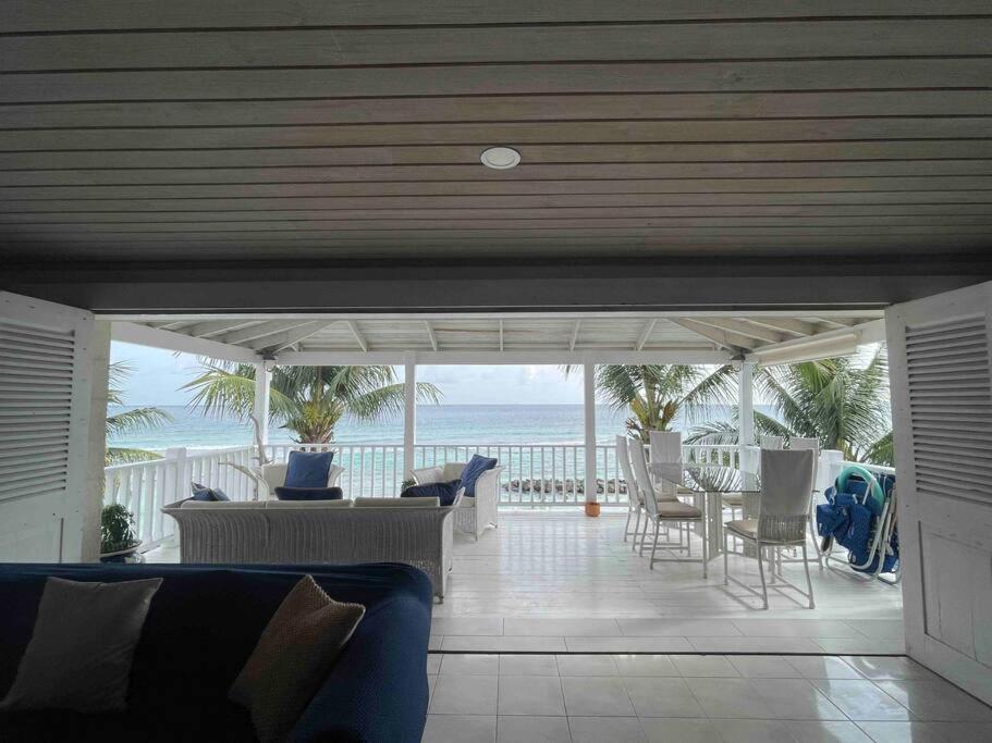 a living room with a view of the ocean at Charleston Beach House Barbados in Bridgetown